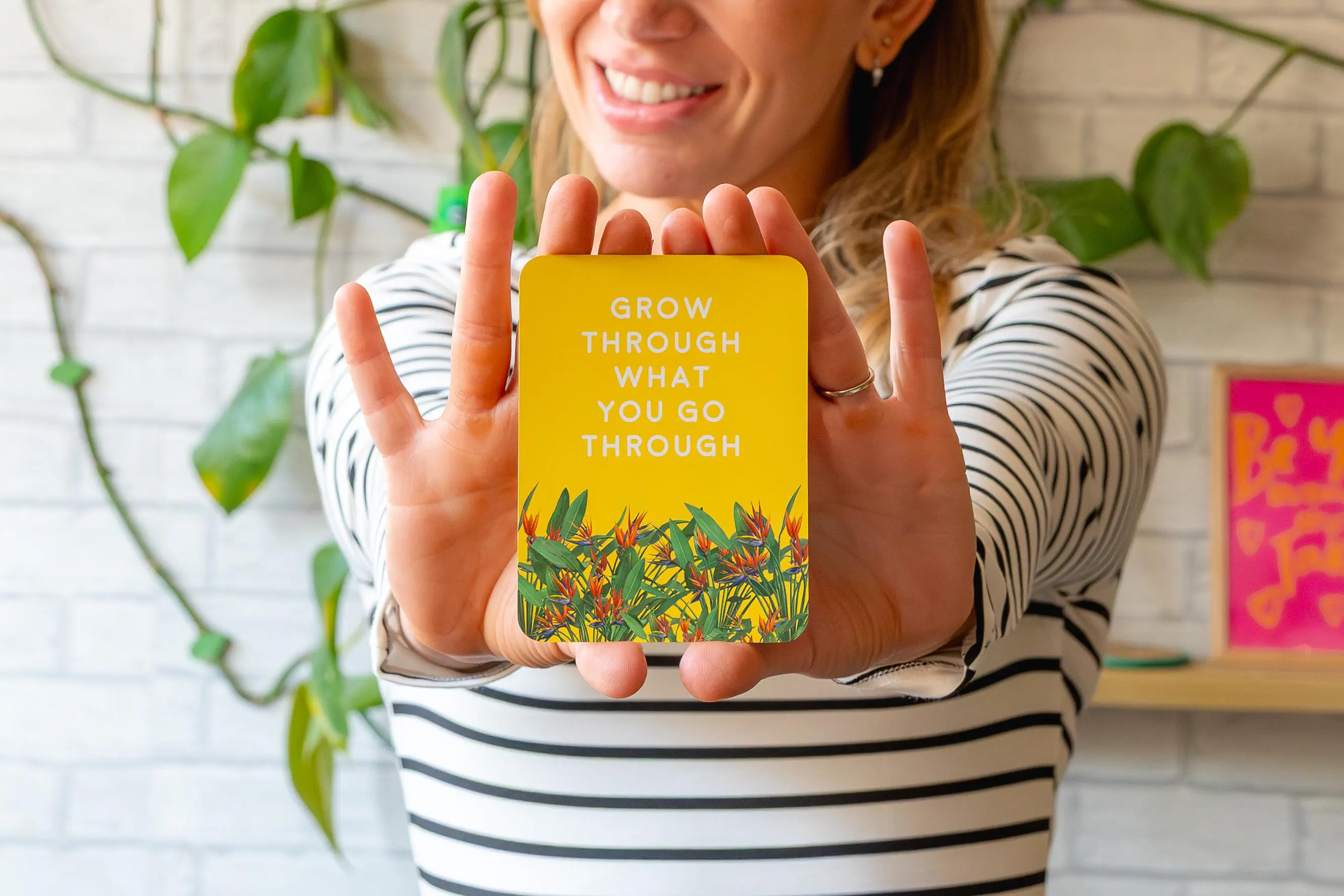 A close-up of a female coach holding a quote card in front of her